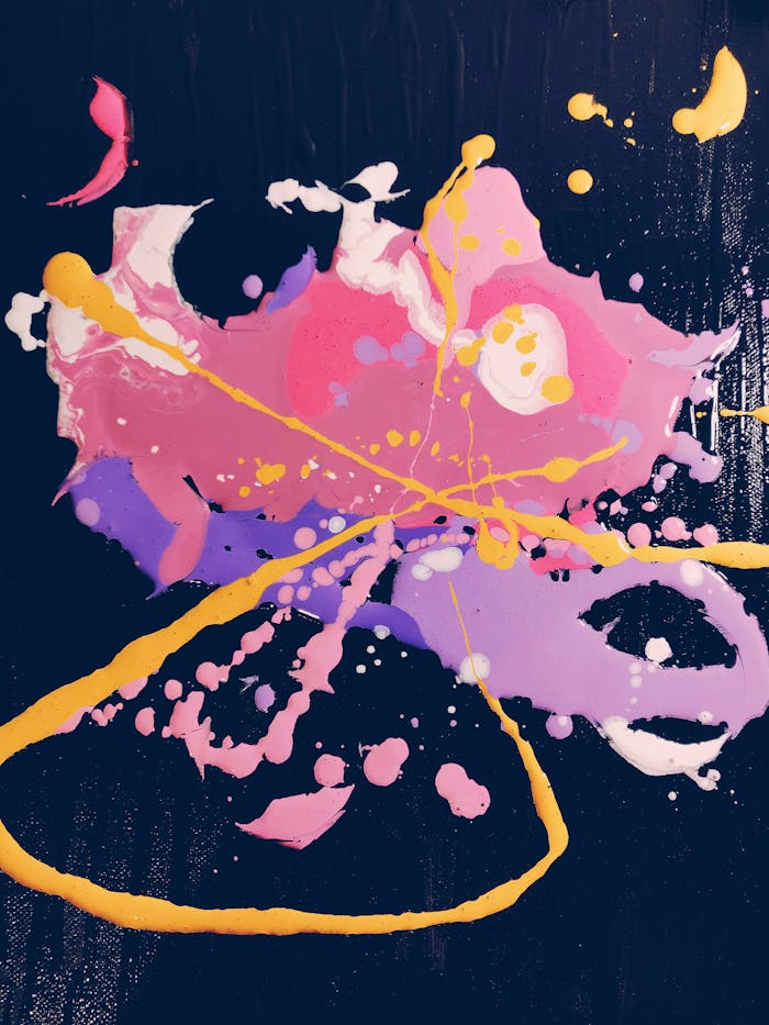 A colorful, vibrant abstract painting with splatters of pink, yellow, and purple on a dark background.